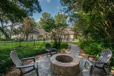 A home with a fire pit in the backyard.