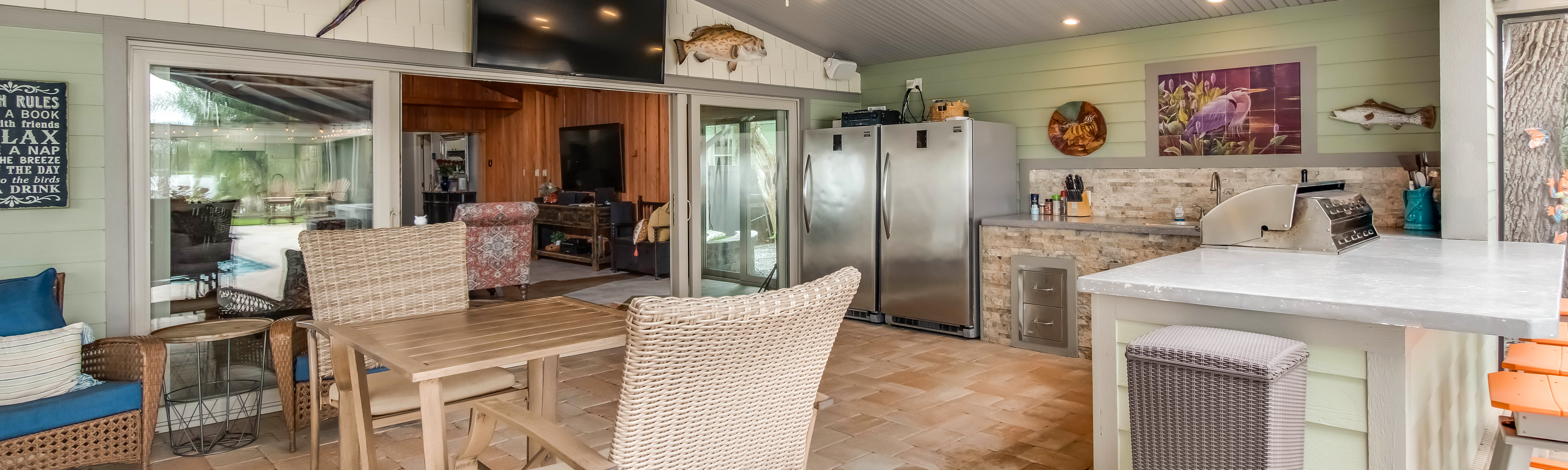 A beautiful outdoor kitchen area with seating.