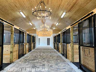 A beautiful barn with chandelier and wood ceiling.