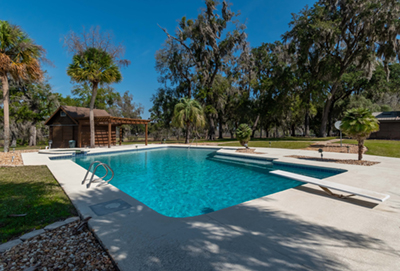 A home with a fire pit in the backyard.