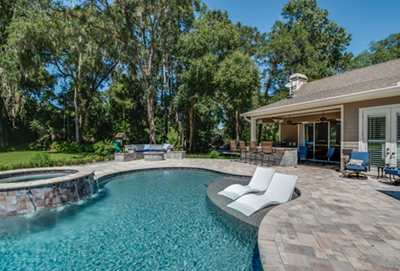 A home with a putting green in the backyard.