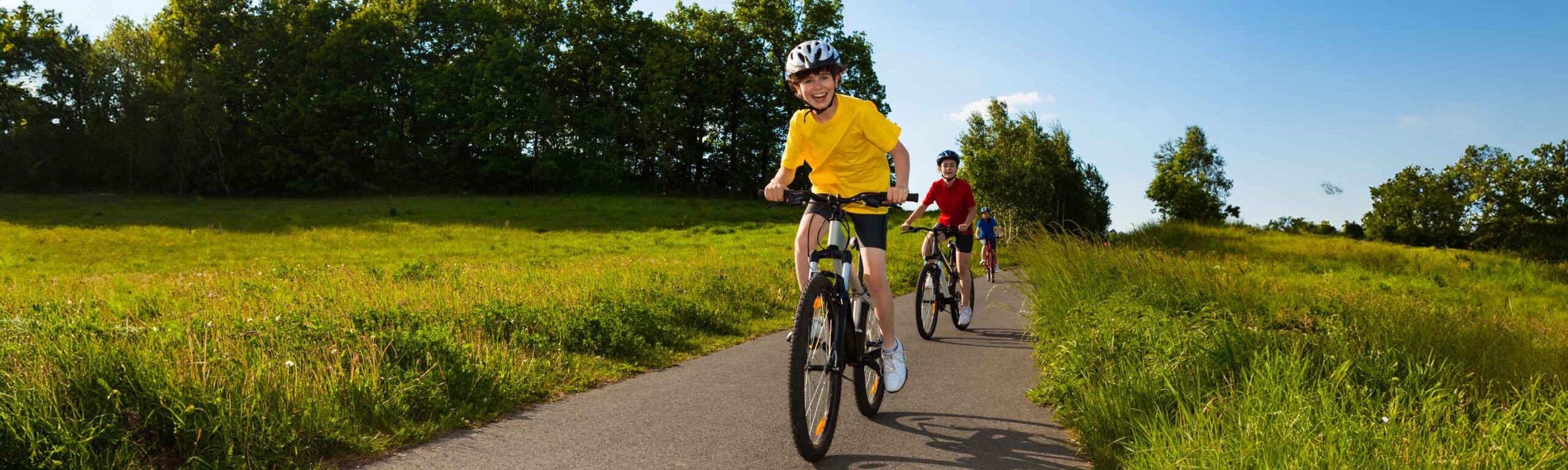 Kids riding bikes on a paved trail