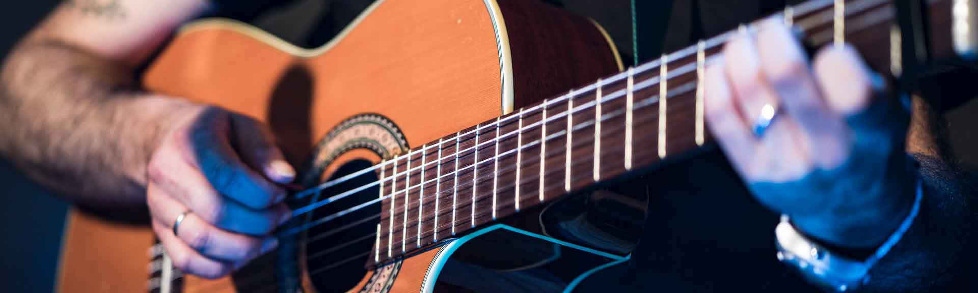 a musician playing an acoustic guitar