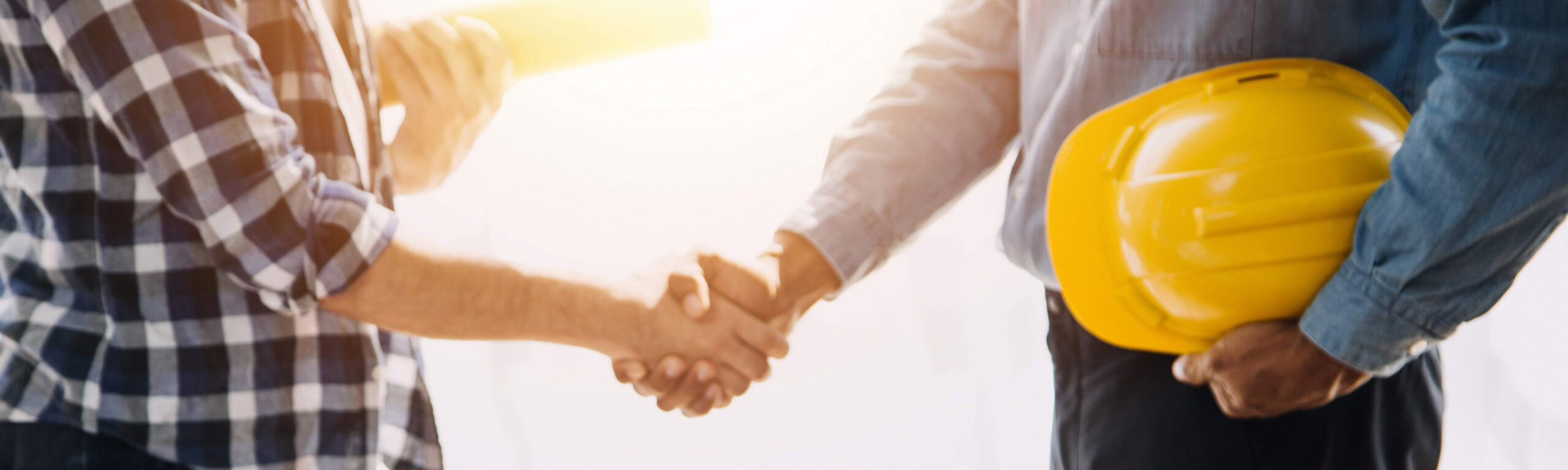  A Builder shaking hands with a client.