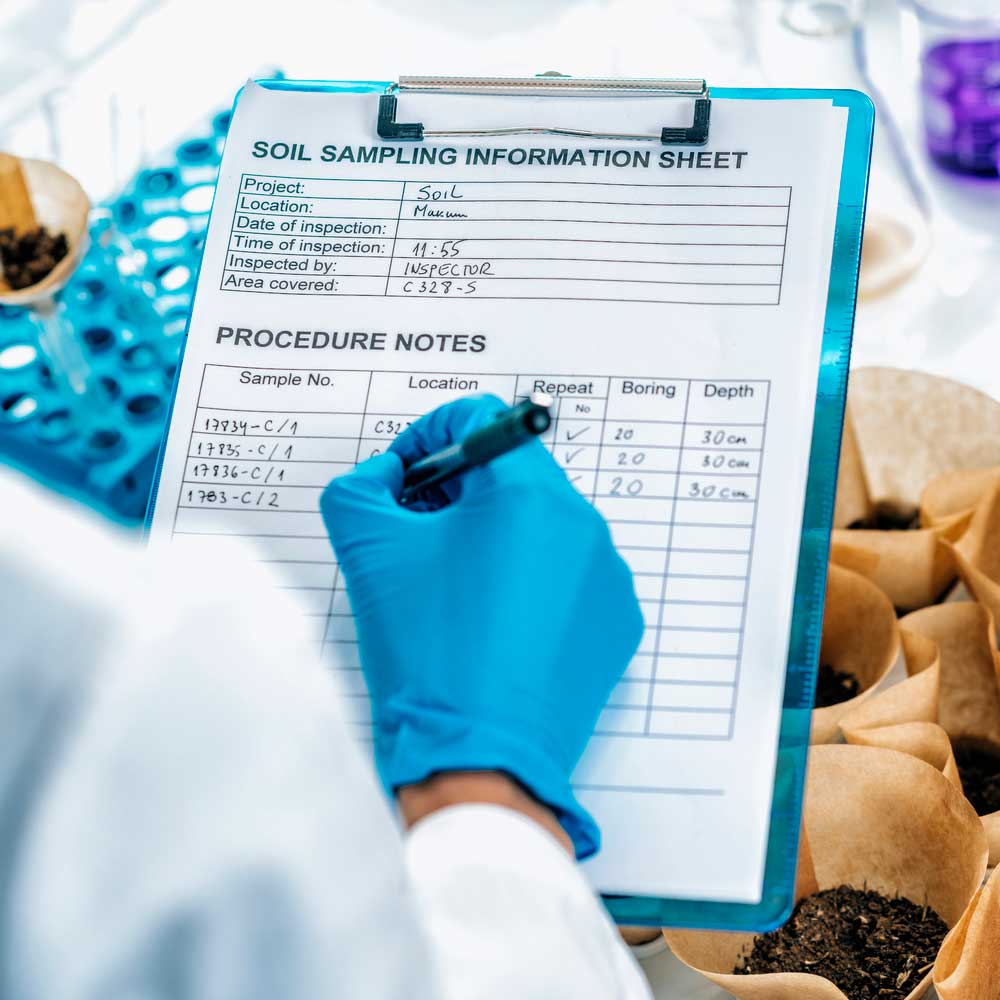 A scientist analyzes soil samples.