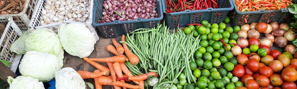 A roadside produce stand with fresh fruits and vegetables.