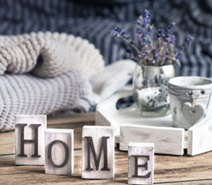 home decorations in the interior of a letter with an inscription home on a wooden background in the interior of the bedroom