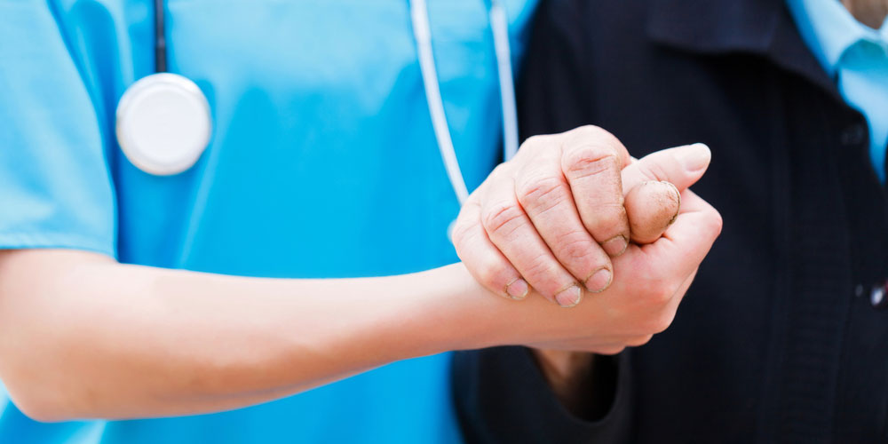 A medical professional assists a patient