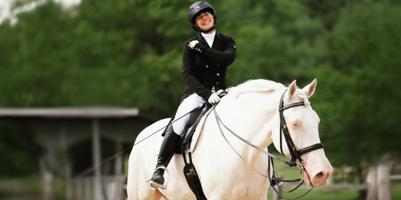 Dana_Dressage Dana Johnson on a white horse in equestrian attire