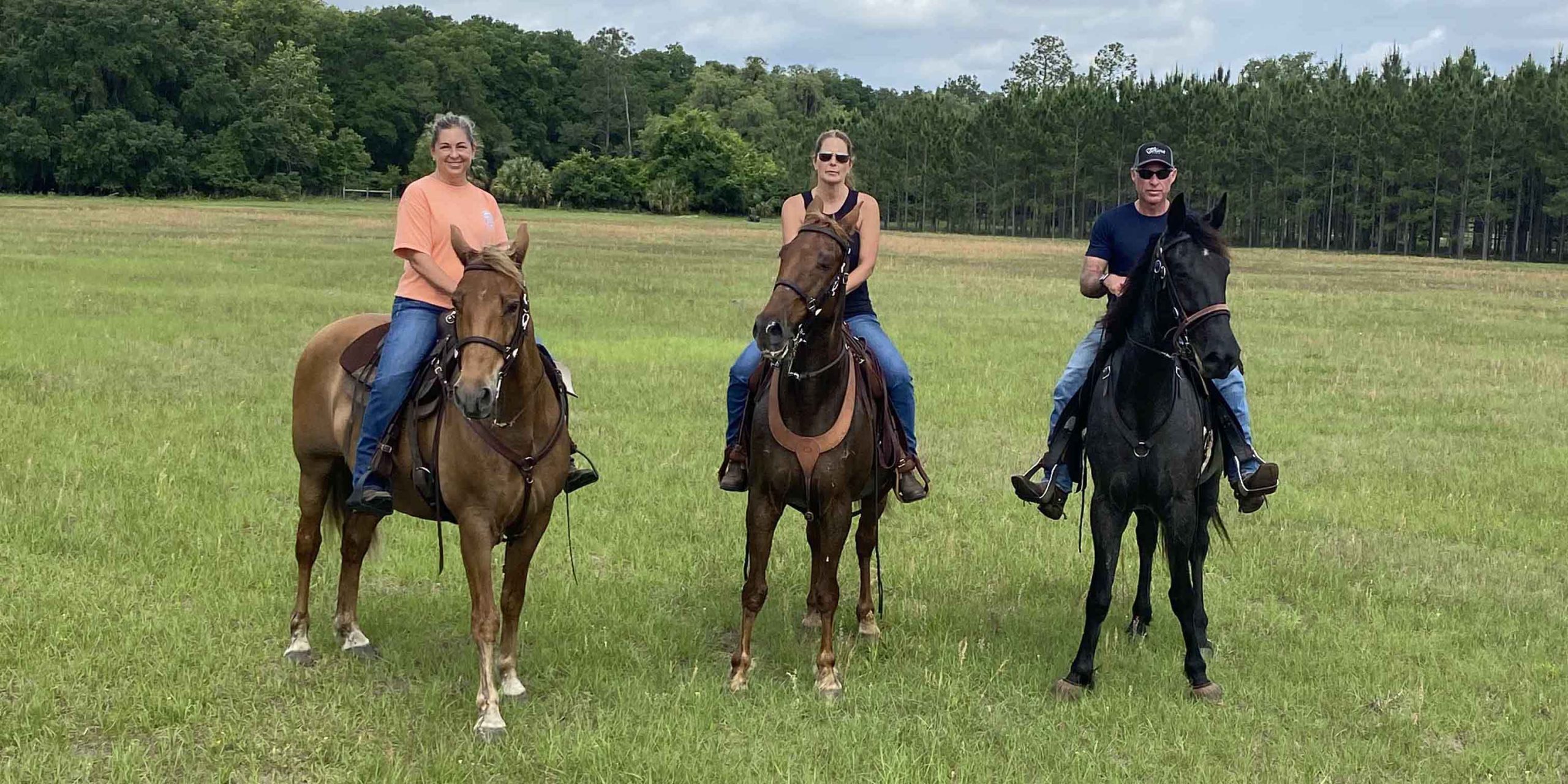 Beckie, her husband and a friend on horseback.